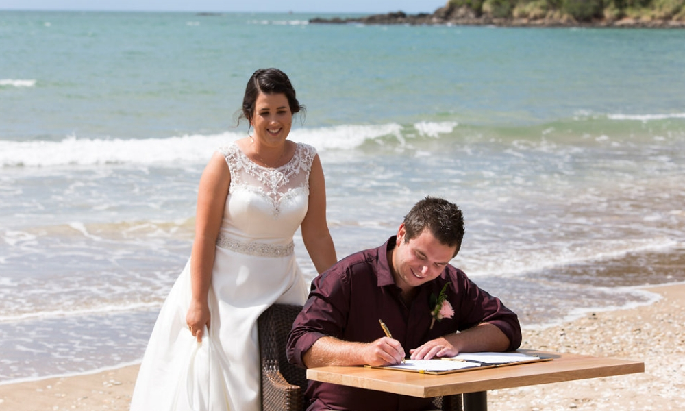 Newly Weds on the beach at Ramada Resort in Taipa